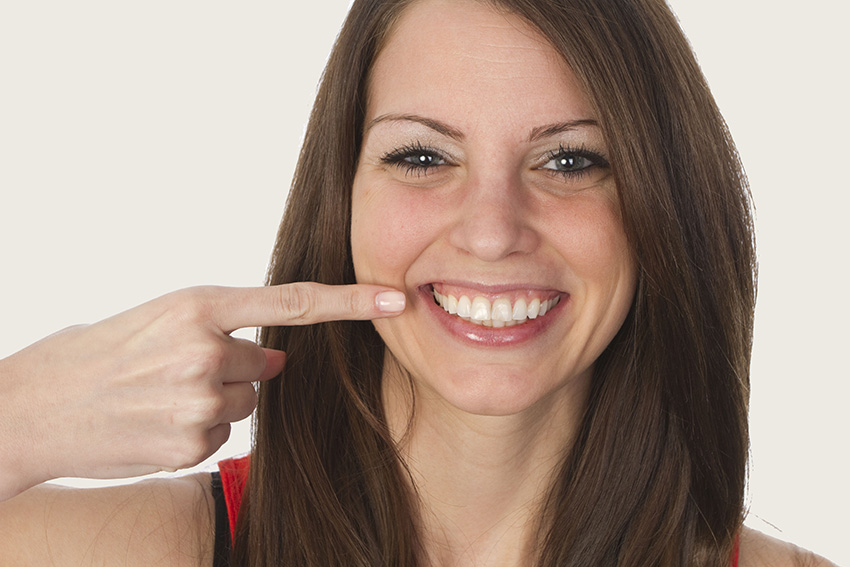 Happy patient after receding gums treatment at Ressler Dental in Delray Beach