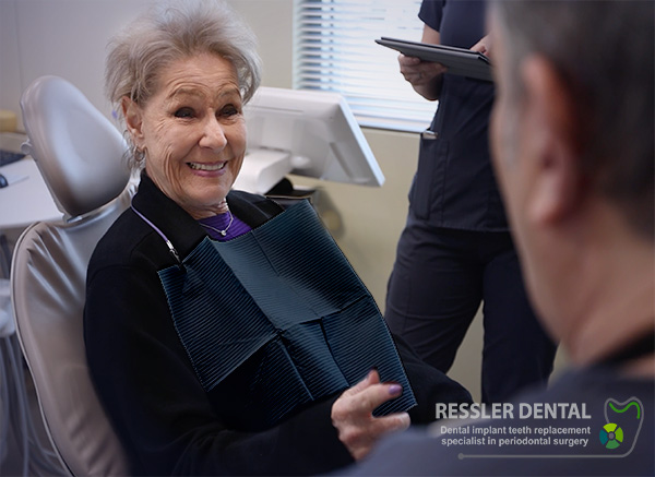 Happy full-arch dental implant patient at Ressler Dental after All-on-4 teeth-in-a-day treatment